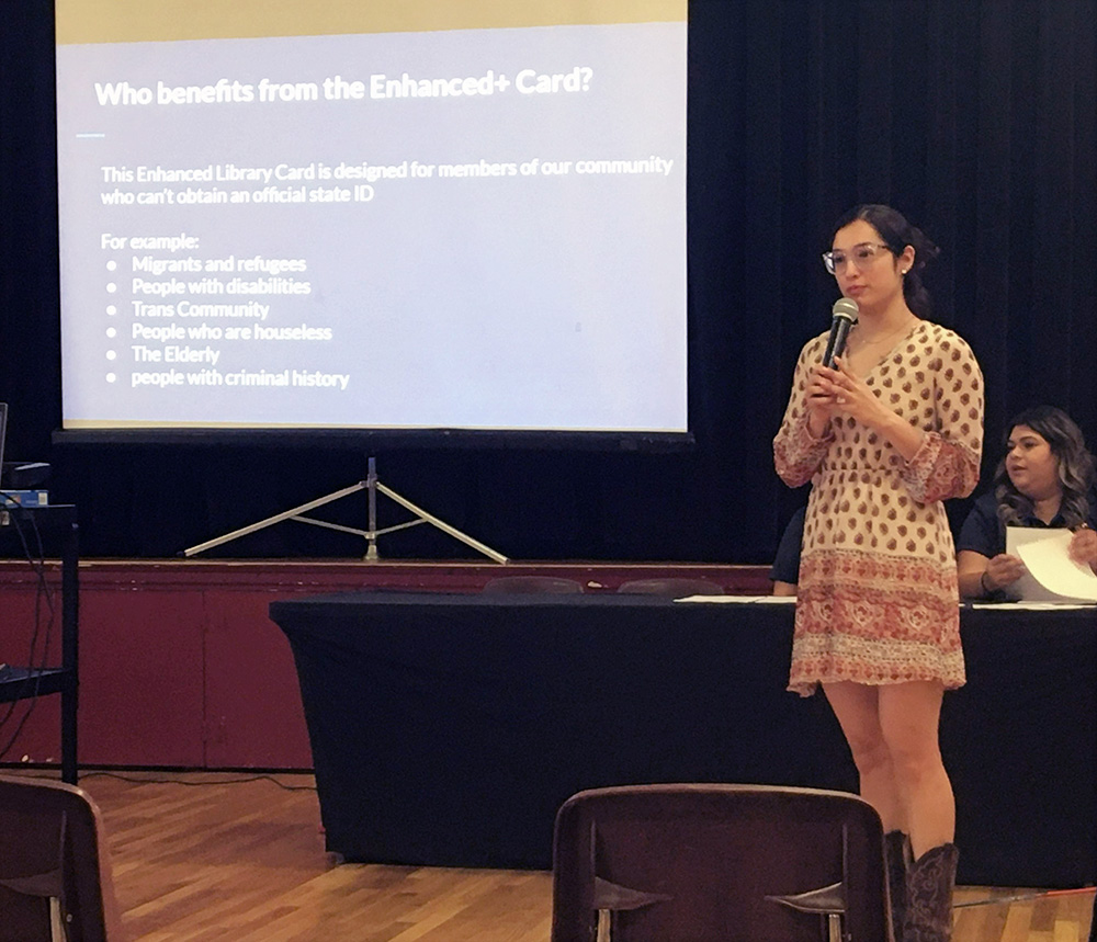 Young woman giving a presentation with slide titled "Who benefits from the Enhanced+ Card?"