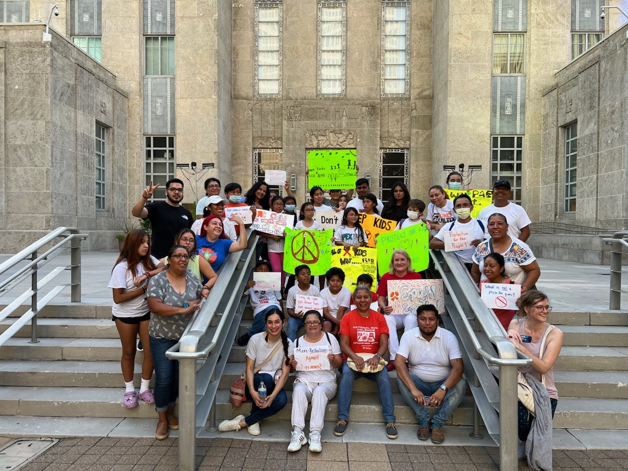 Kitchen Table participants holding signs at a protest against gun violence.